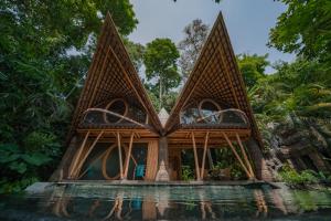 a house in the middle of a body of water at Suenyo Eco Retreat in Tabanan