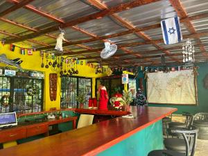 a bar with a wooden counter in a room at Coco Hotel and Hostel in Sosúa