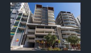 two tall apartment buildings next to each other at Discover urban bliss in our 1-bedroom King bed apartment! City views and cultural gems in Brisbane