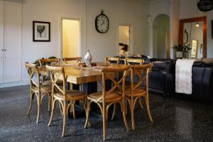a dining room with a wooden table and chairs at Barossa Bed & Breakfast in Tanunda