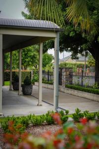 einen Pavillon in einem Park mit einem Zaun und Blumen in der Unterkunft Barossa Bed & Breakfast in Tanunda