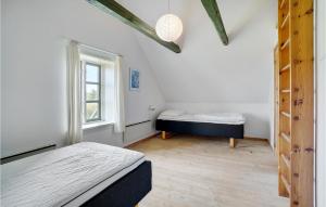 a bedroom with two beds and a window at Beautiful Home In Dronningmlle With 4 Bedrooms, Sauna And Wifi in Dronningmølle