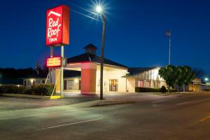 a fast food restaurant with a sign in front of it at Red Roof Inn Childress in Childress