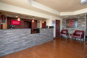 a lobby of a red roof inn with chairs and a bar at Red Roof Inn Childress in Childress