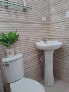 a bathroom with a toilet and a sink at SDQ Apartamento Marbella 3 in La Ureña +8 photos