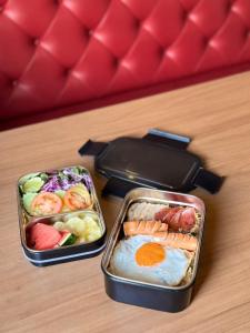 two lunch boxes with food in them on a table at The Terminal Khon Kaen Hotel in Khon Kaen