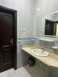 a bathroom with a sink and a mirror at شقة مطلة على قباء in Medina