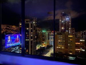 a view of a city at night from a window at Confort y comodidad in La Paz