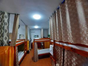Zimmer mit 2 Etagenbetten und Vorhängen in der Unterkunft 3 Sisters Guest House 1 in Moalboal