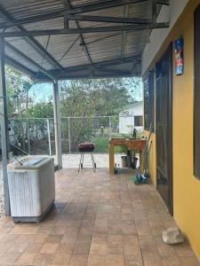 a covered patio with a table and a bench at Casa Sendero in Liberia