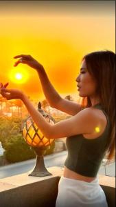 a woman standing next to a vase with the sunset at Pyramids sunrise inn in Cairo