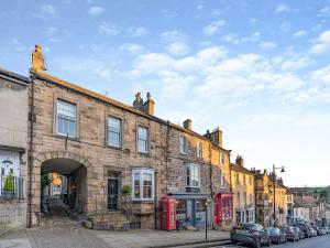 an old brick building with a red phone booth at Old Bank House in Barnard Castle