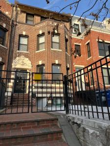 a black fence in front of a brick building at Large DUPLEX Apt 2Bdrm 1Den-Metro in Washington