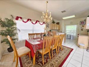 a dining room and kitchen with a table and chairs at Elysian deluxe villa in Davenport