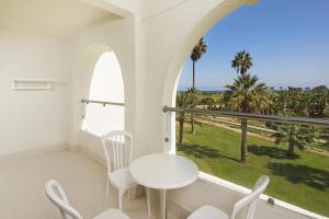 a white room with a table and chairs and a window at Iberostar Selection Diar El Andalous in Port El Kantaoui