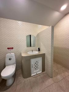 a bathroom with a toilet and a sink at Garden Villa Khaolak in Khao Lak