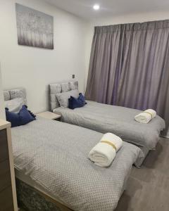 a room with two beds with pillows on them at 2 Bedrooms 2Baths 3Toilets near Excel City Airport O2 Sleeps up to 5 in London