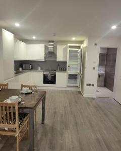 a large kitchen with a table and a dining room at 2 Bedrooms 2Baths 3Toilets near Excel City Airport O2 Sleeps up to 5 in London