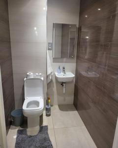 a bathroom with a toilet and a sink at 2 Bedrooms 2Baths 3Toilets near Excel City Airport O2 Sleeps up to 5 in London