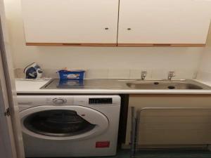 a kitchen with a washing machine and a sink at Pass the Keys Superb 1st Floor Town Centre Apartment Refurbished in Grimsby