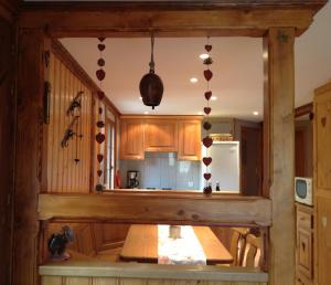 a kitchen with a table and a refrigerator at Les Bouquetins in Stosswihr