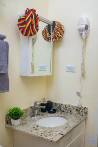 a bathroom counter with a sink and a lamp at Charming refuge at Colbeck Manor in Old Harbour