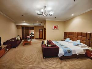 a large bedroom with a bed and a couch at Chongqing Milky Way Hotel in Chongqing