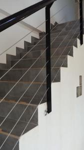 a set of stairs with a glass railing at Don Will Aparts in Puerto Esperanza