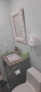a bathroom with a sink and a mirror at Cozyhideaway in Providenciales