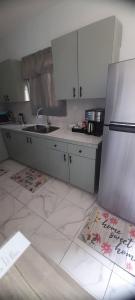 a kitchen with a sink and a refrigerator at Cozyhideaway in Providenciales