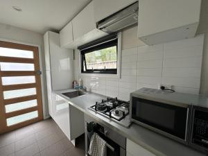 a kitchen with a stove and a sink and a window at Dynamic 2 Bedroom home close to city buzz Darling St 2 E-Bikes Included in Sydney