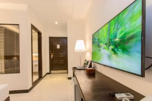 a living room with a large screen tv on the wall at Cambodian Country Club in Phnom Penh