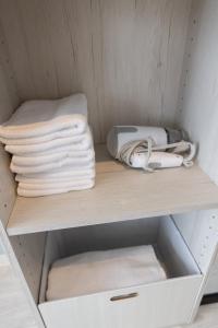 a cupboard with towels and towels on a shelf at KIKU'S Room in Osaka