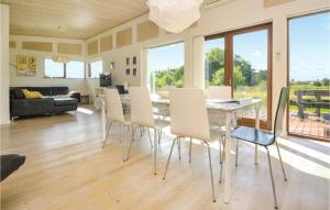 a dining room and living room with a table and chairs at Stunning Home In Haderslev With 4 Bedrooms, Sauna And Wifi in Årøsund
