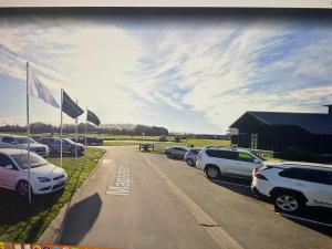 a bunch of cars parked in a parking lot at Pegasus Amberley, Entire Studio in Waikuku