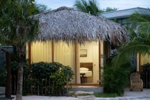 a small hut with a straw roof at OLIVE Camping in La Gi