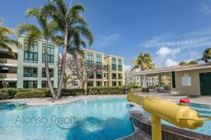 a pool with a slide in front of a building at 3 Bed 2 Bath 2 Parking 5 pools in Loiza