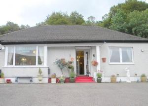 a white house with a red carpet in front of it at Alltonside Guest House in Fort William