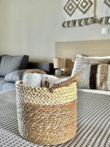 a basket sitting on a bed in a living room at Anatoli Halkidiki in Afitos