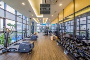 a gym with treadmills and machines in a building at Lovely Eco Home in Gelang Patah