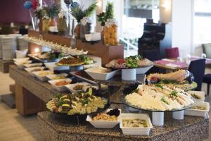 a buffet line with many different types of food at Altin Yunus Hotel & SPA - Çeşme in Cesme