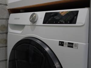 a white washing machine sitting next to a wall at OCEA84 - Quinns Beach Shack: Ocean Views in Quinns Rocks