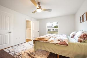 a bedroom with a bed and a ceiling fan at Sunny Palm Coast: 3BR Harmony in Palm Coast