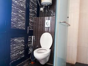 a bathroom with a white toilet in a stall at Hauz Khas Villa 2 in New Delhi