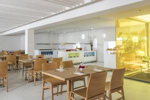a dining room with wooden tables and chairs at Iberostar Selection Diar El Andalous in Port El Kantaoui