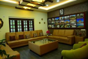 a living room with couches and a coffee table at Serenity Cottage Luxury Homestay Virajpet in Virajpet