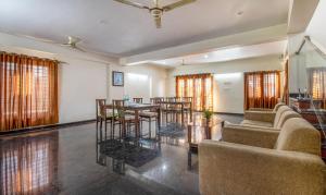 a living room with a table and chairs at Treebo Trend RR Residency - Sanjay Nagar in Bangalore