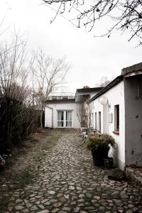 a white house with a stone driveway in front of it at Hamburg - 2 Bedrooms for up to 11 guests in Hamburg