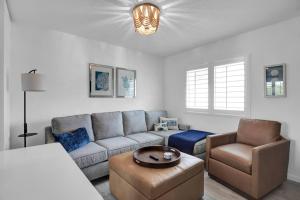 a living room with a couch and a chair at Keys Wade NEW 1B 2Bath in Marathon +34 photos