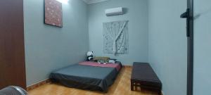 a small bedroom with a bed and a table at LeMin Homestay in Hai Phong